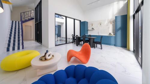 a living room with colorful furniture and a dining room at Le Pavilion Pool Villa in Pohang