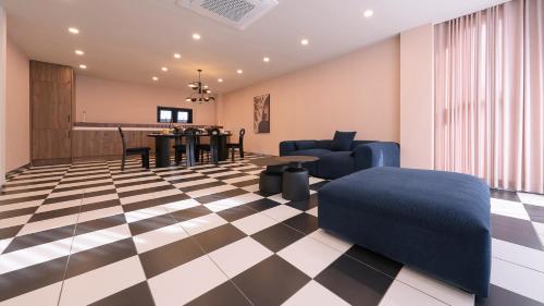 a living room with a checkered floor at Le Pavilion Pool Villa in Pohang