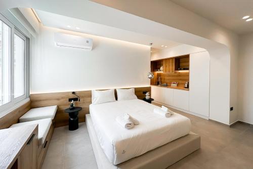 a bedroom with a large white bed and a window at Megaro Luxury Suite 11 in Syntagma in Athens
