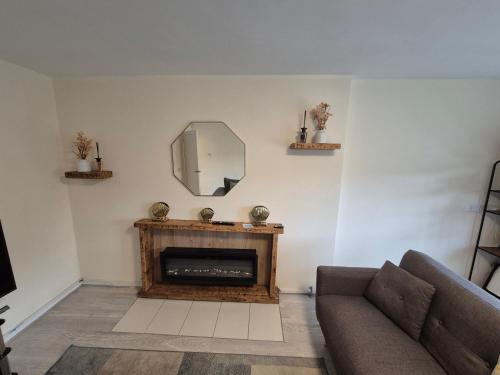 a living room with a couch and a mirror at Lovely & Beautiful 2 Bed-Apartment in Borehamwood in Borehamwood