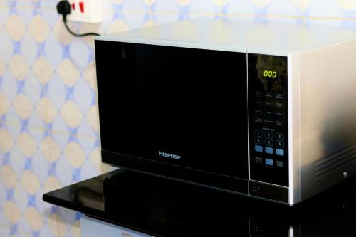 a microwave oven sitting on top of a counter at Mwanza city escape in Mwanza