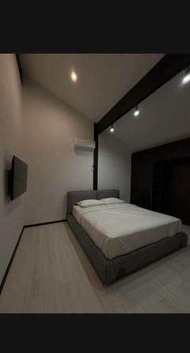 a bedroom with a bed and a flat screen tv at Фахверк Боровое in Zhezdi