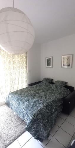 - une chambre avec un lit doté d'une couverture bleue dans l'établissement Studio ensoleillé centre ville tour Luma, à Arles