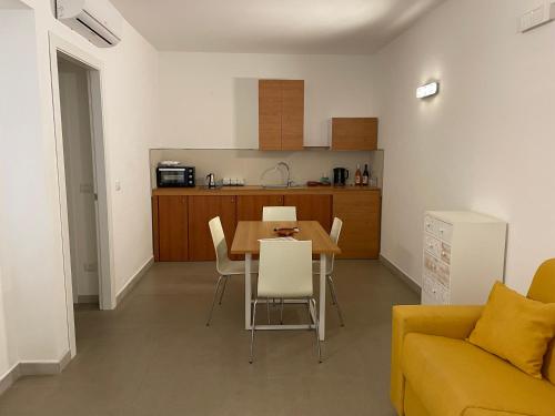 a living room and kitchen with a table and chairs at Don Vittorio Country Village in Taormina