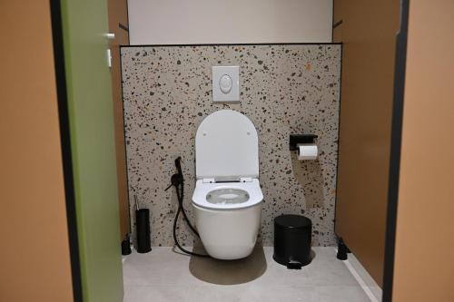 a bathroom with a white toilet in a stall at Top view hostel in Durrës