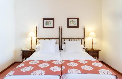 a bedroom with a large bed with two lamps at Hotel Bon Sol Resort & Spa in Illetas