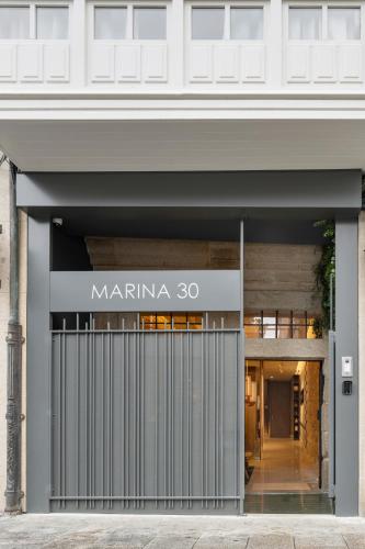 a store front with a sign that reads marina at Marina 30 in A Coruña