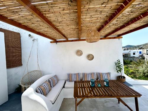 a porch with a couch and a swing at Babatseratsi skyrian studio 1 in Skiros