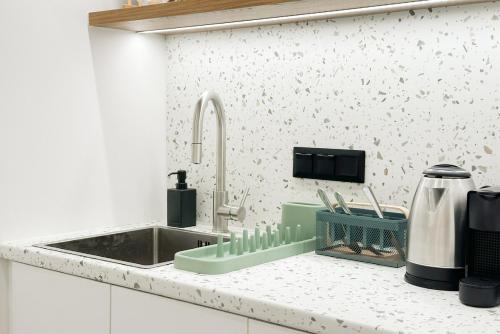 a kitchen counter top with a sink and a sink at Megaro Luxury Suite 7 in Syntagma in Athens