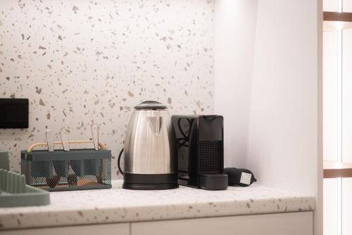 a kitchen counter with a coffee maker on a counter top at Megaro Luxury Suite 7 in Syntagma in Athens