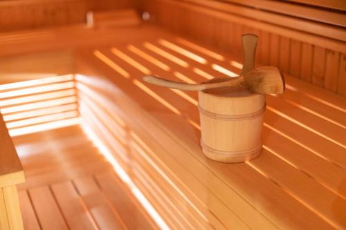 a wooden spoon in a cup in a sauna at Eschenhof Bed & Breakfast in Kaprun