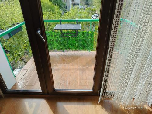 a sliding glass door with a view of a deck at ARKA Apartment in Craiova