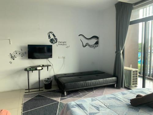 a living room with a couch and some stickers on the wall at HOMEY-Sleepy Don Mueang Airport Hostel in Bangkok