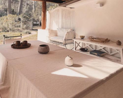 a room with a table with a couch and a chair at Villa Kalimera in Ginosa Marina