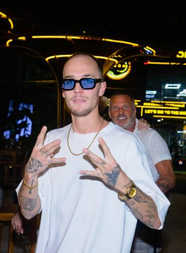 a man wearing sunglasses and tattoos on his hands at Happy Bear Hostel Phu Quoc in Phu Quoc