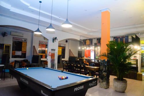 a pool table in the middle of a room at Happy Bear Hostel Phu Quoc in Phu Quoc
