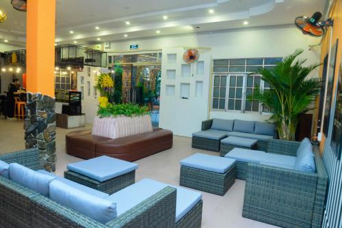 a lobby with couches and tables in a store at Happy Bear Hostel Phu Quoc in Phu Quoc