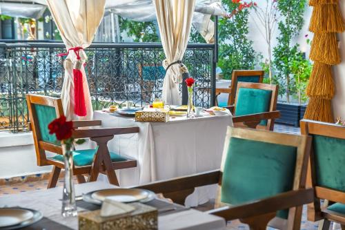 a dining room with a table and chairs at Riad Diamond Of Marrakech & Spa in Marrakech