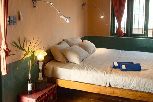 a bedroom with a bed with white sheets and pillows at Hill Village Phu Yen in Phú Hiệp (2)