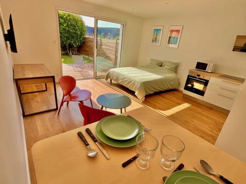 a living room with a table and a bedroom at Charmant studio Pornicais in Pornic