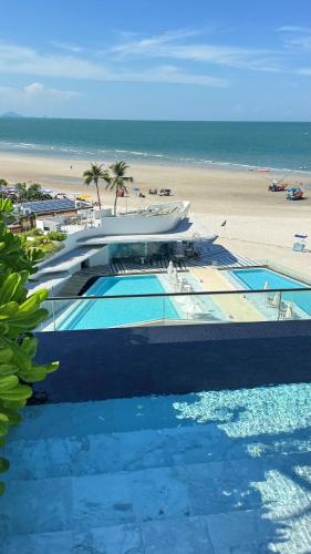 a view of a swimming pool next to a beach at Veranda by Welcome Hua Hin in Hua Hin