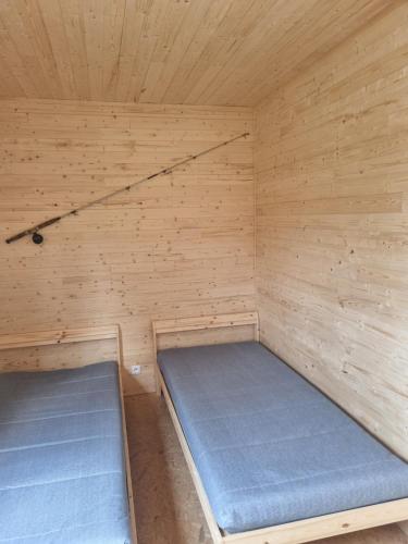 a small room with two beds in a sauna at Rybářský sen in Olbramkostel