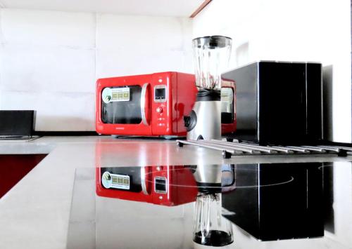a kitchen with a red blender on a counter at Refreshing Oasis in El Médano