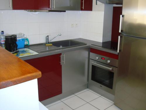 une cuisine avec un évier et une cuisinière dans l'établissement résidentiel, à La Rochelle