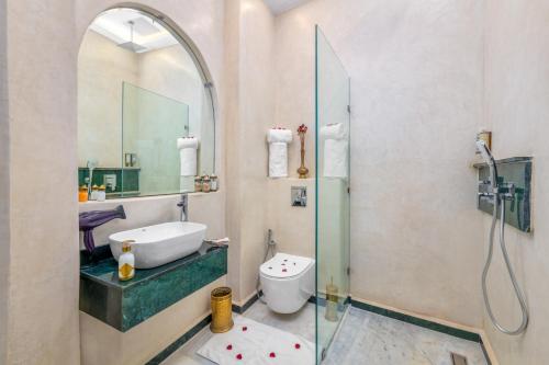 a bathroom with a shower and a sink and a toilet at Riad Diamond Of Marrakech & Spa in Marrakech