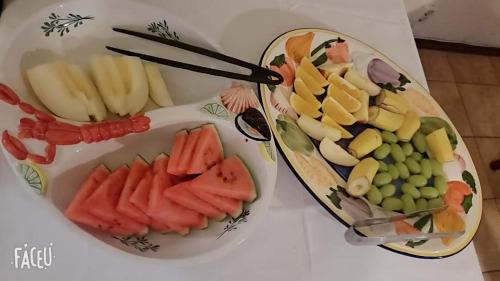 two plates of fruit and vegetables on a table at Vingåker Hotell in Vingåker