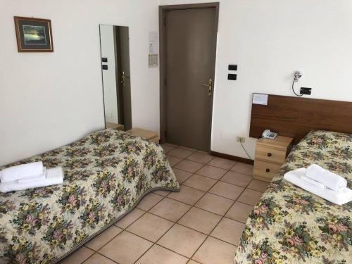 A bed or beds in a room at BE ME Hotel Helvetia
