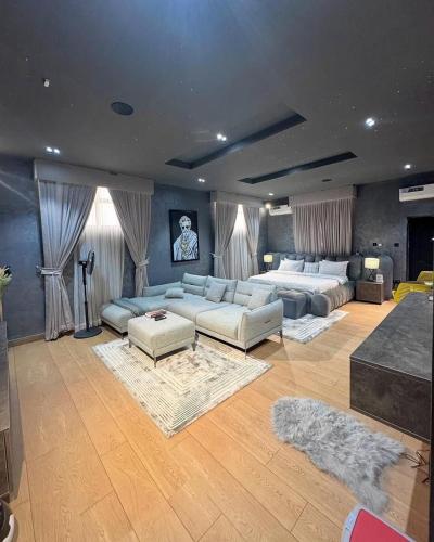a large living room with two beds and couches at Luxury 3 bedroom gwarinpa in Abuja