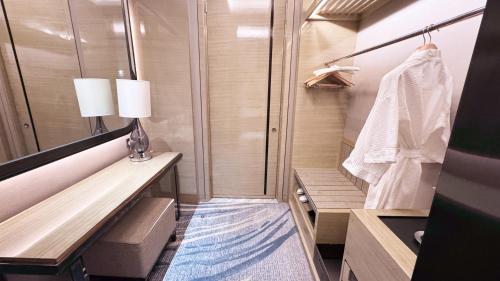 a small bathroom with a shower and a towel at Wanda Realm Changzhou in Changzhou