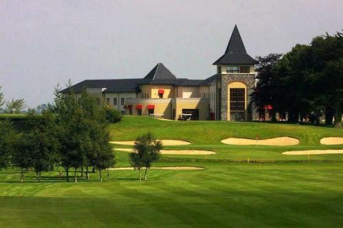a view of a golf course with a building at Brookhaven Lodge in Kilteely