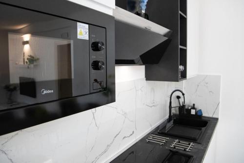 a kitchen with a sink and a mirror at Apartment24 in Colle di Val d'Elsa