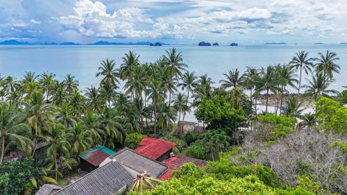 an aerial view of a resort and the ocean at Beachfront Wooden Beach House 3br Sunset View in Taling Ngam Beach