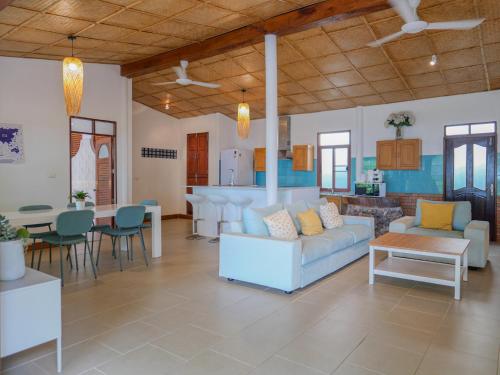 a large living room with a couch and a table at Beachfront Wooden Beach House 3br Sunset View in Taling Ngam Beach