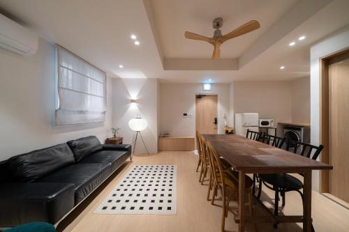 a living room with a black couch and a table at Trip made in Busan