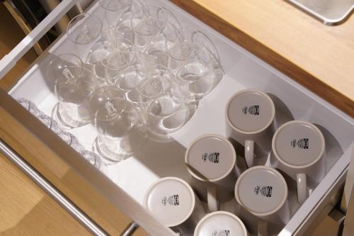 a bunch of wine glasses in a drawer at Trip made in Busan
