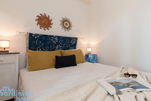 a bedroom with a bed with a book on it at Few steps from the sea in Golfo Aranci