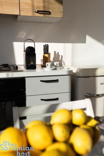a kitchen with a bunch of lemons on a table at Few steps from the sea in Golfo Aranci