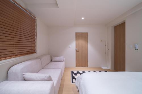 a living room with a couch and a bed at Trip made in Busan