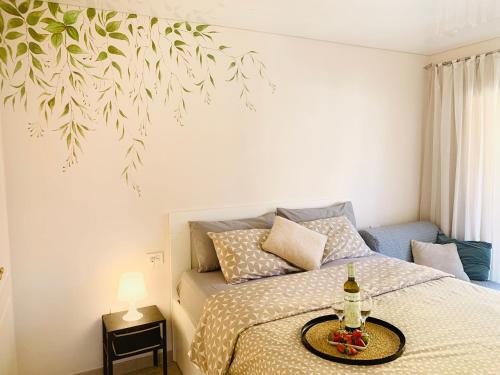 a bedroom with a bed with a table on it at Large Terrace Jardin Apartment in Puerto de Santiago