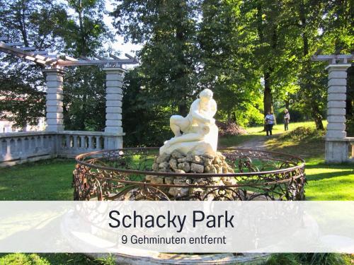 a statue in a park with the wordsshaw park centennial enrichment at SEEZEIT Ferienwohnungen & Seminarhaus am Ammersee in Dießen am Ammersee