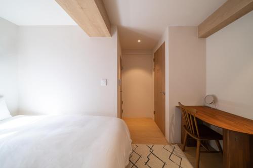 a bedroom with a bed and a desk at Trip made in Busan