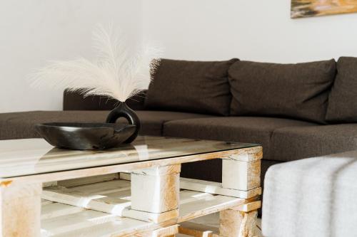 a coffee table with a black bowl with feathers on it at StelAnna-Apartments in Rethymno Town