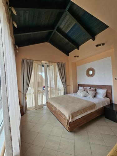 a bedroom with a large bed in a room at Marily's seaview suite with private JACUZZI and BBQ in Spartia