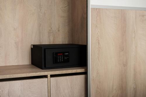 a microwave sitting on a shelf in a kitchen at StelAnna-Apartments in Rethymno Town