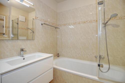 a bathroom with a tub and a sink and a shower at Villa Seepferdchen Wohnung 09 in Kühlungsborn