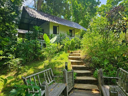 a stairway leading to a house with two benches at NernJamsai in Sop Poeng